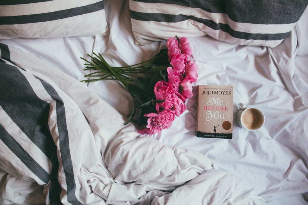 Bed, book, flowers, hot drink. Be kind to yourself. Duvet day.